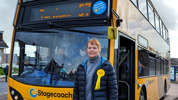 Dianne Cotton with a yellow Stagegoach no. 57 bus